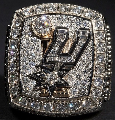 The San Antonio Spurs championship rings are lined up in front to the Larry  O'Brian trophy for a ring ceremony prior to an NBA basketball game between  the Spurs and the Dallas